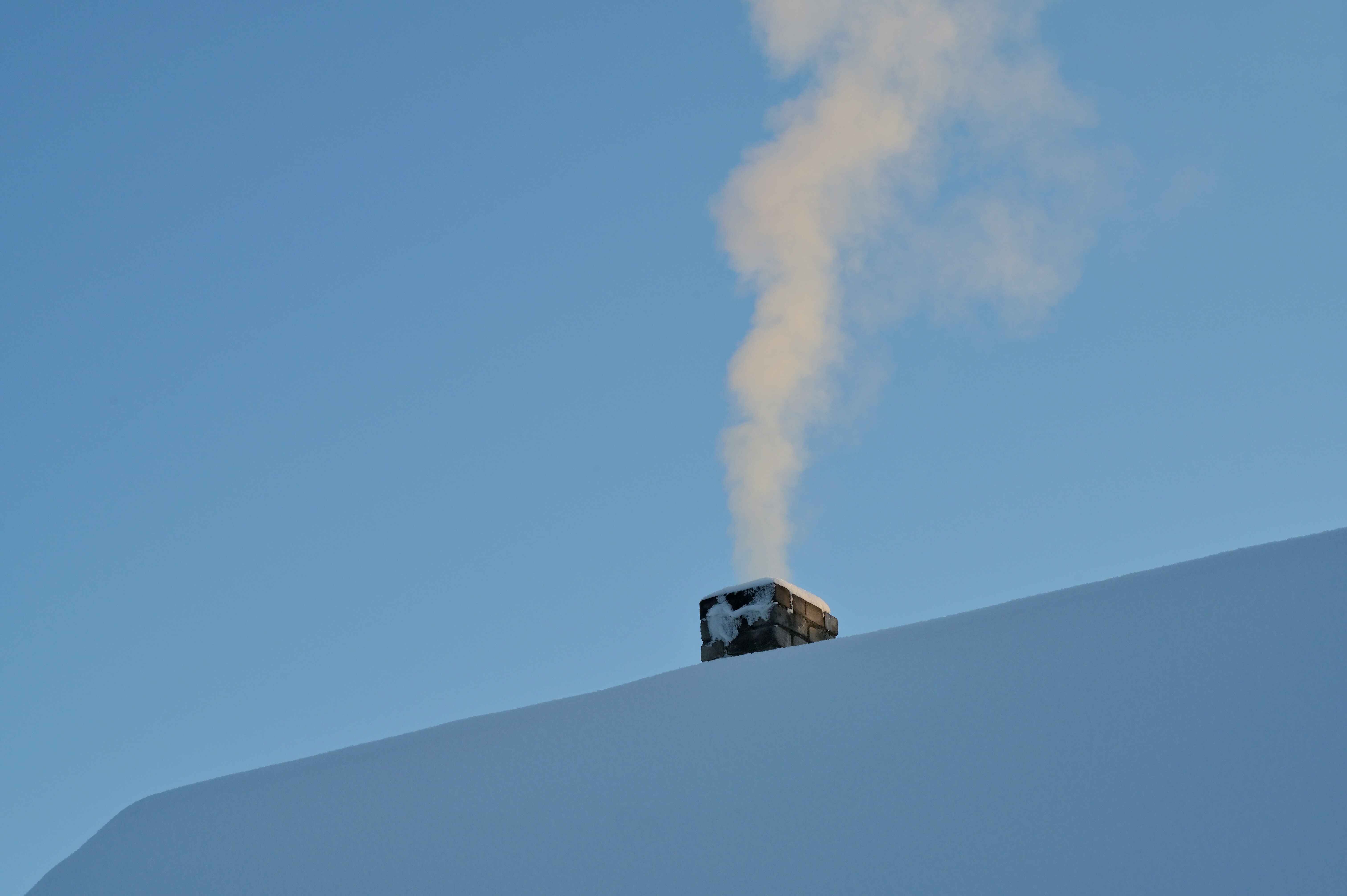 Attic vents on a home exterior in winter