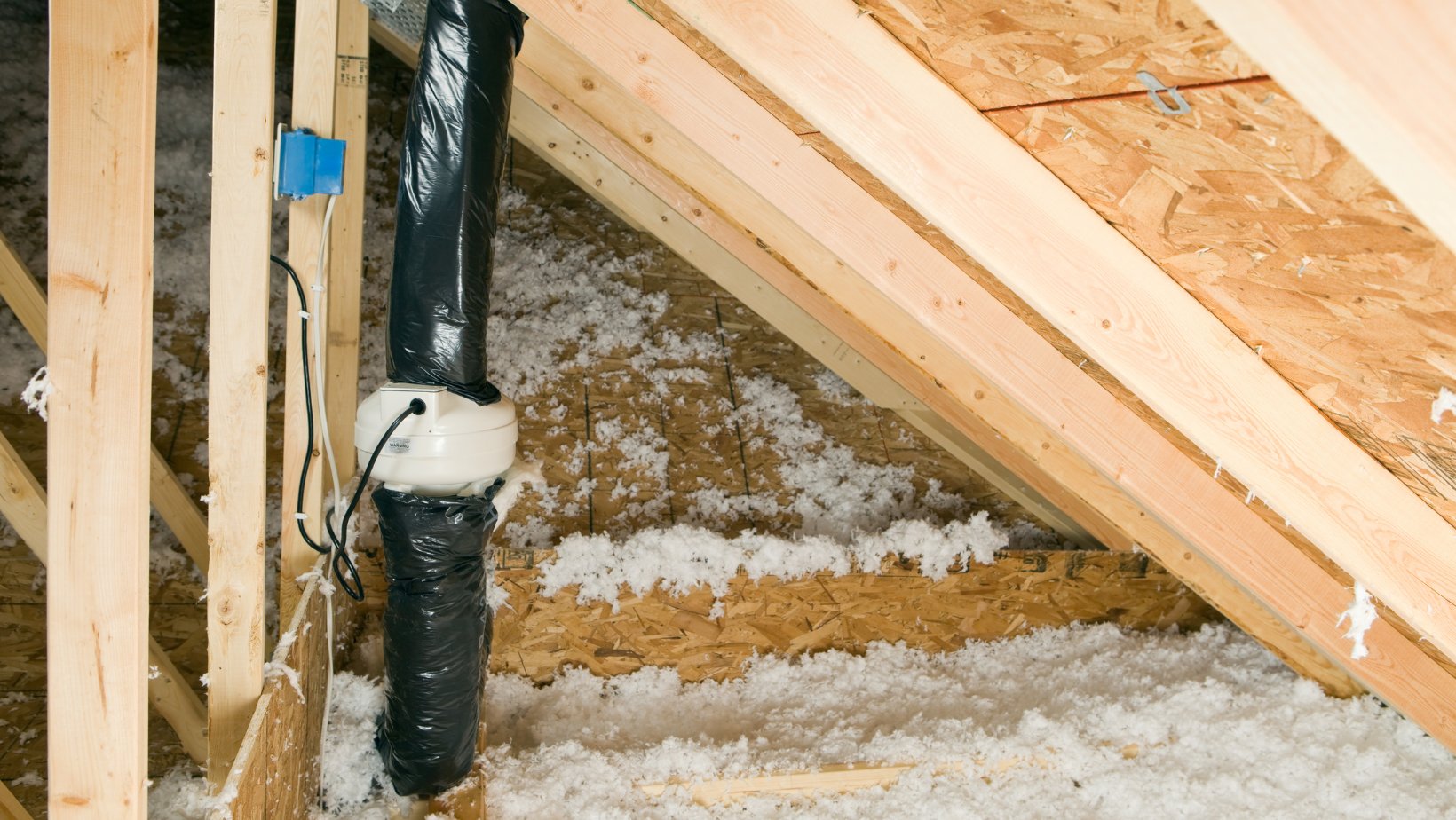 Blown-in insulation being installed in a Dallas home attic