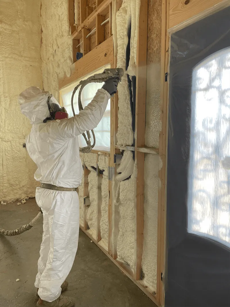 Spray foam insulation being applied to an attic roof deck