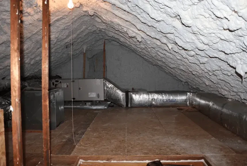 Attic roof deck and ductwork sealed with spray foam insulation